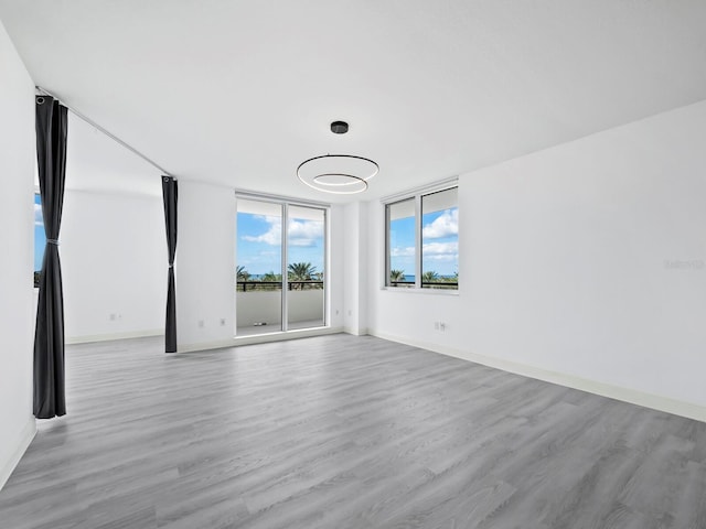 empty room with light hardwood / wood-style flooring