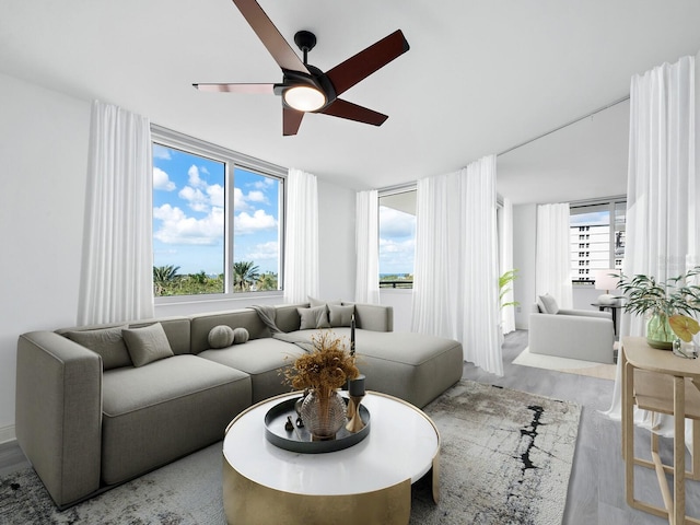 living room featuring light wood-type flooring and ceiling fan