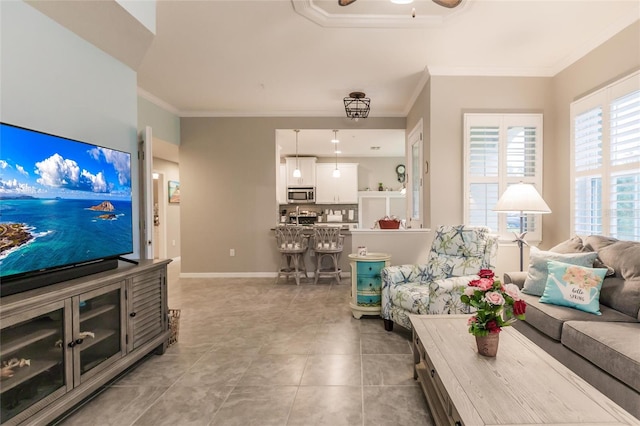 tiled living room with ceiling fan and crown molding