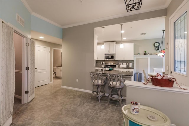 interior space with backsplash, crown molding, and tile patterned floors