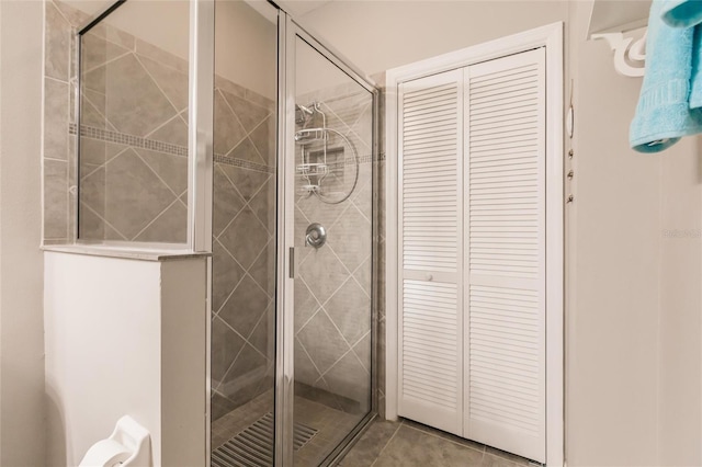 bathroom featuring tile patterned flooring and a shower with door