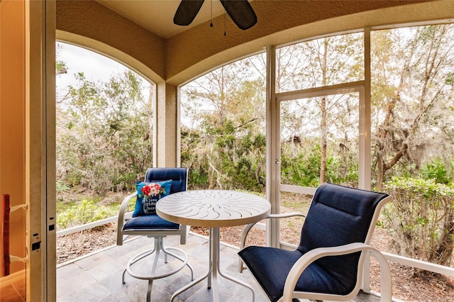 sunroom featuring ceiling fan