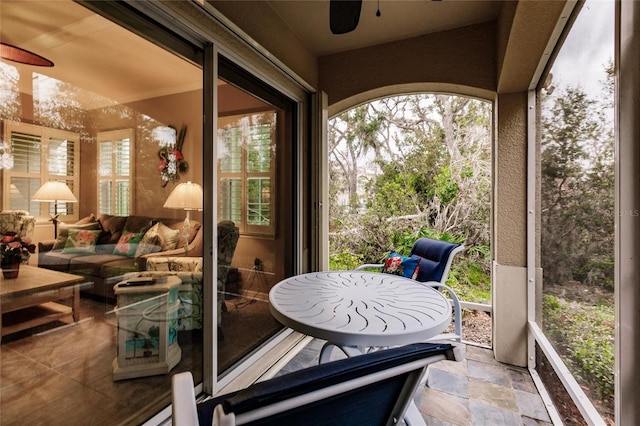 sunroom / solarium with ceiling fan and plenty of natural light