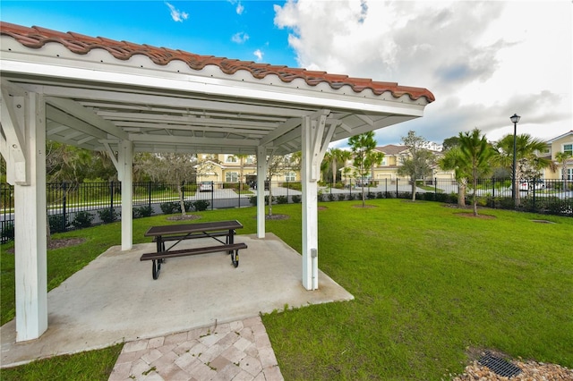 surrounding community featuring a lawn and a patio area