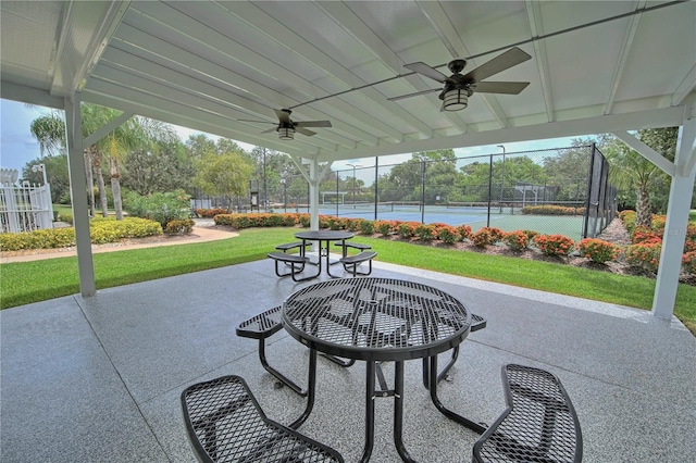 view of patio / terrace with tennis court and ceiling fan