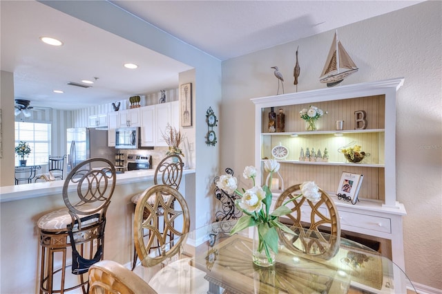 dining space featuring ceiling fan