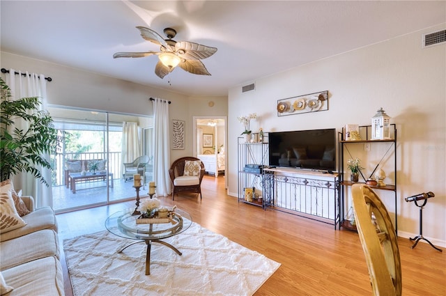 living room with hardwood / wood-style flooring and ceiling fan