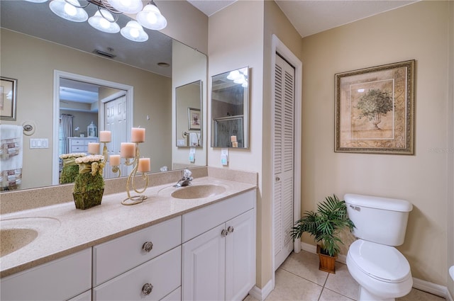 bathroom with toilet, tile patterned floors, and vanity