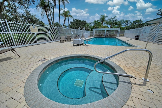 view of swimming pool with a community hot tub and a patio