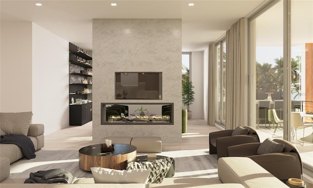 living room with floor to ceiling windows and light wood-type flooring