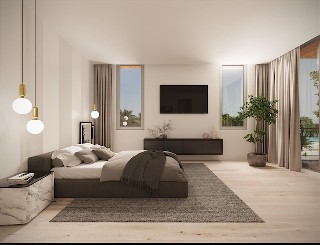 bedroom with a wall of windows and light hardwood / wood-style flooring