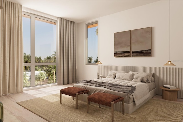 bedroom featuring light wood-type flooring and a wall of windows