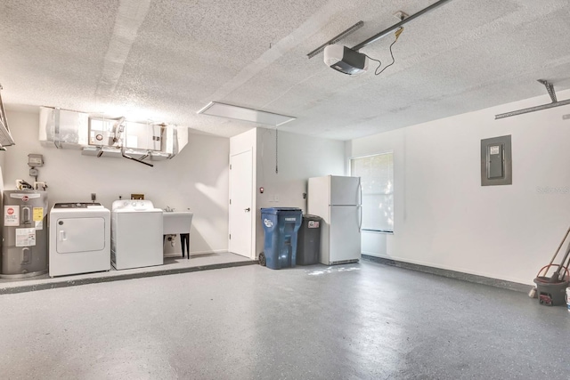 garage featuring water heater, white refrigerator, washing machine and dryer, electric panel, and a garage door opener