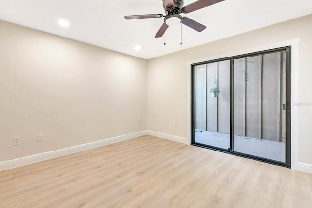 spare room with light hardwood / wood-style flooring and ceiling fan