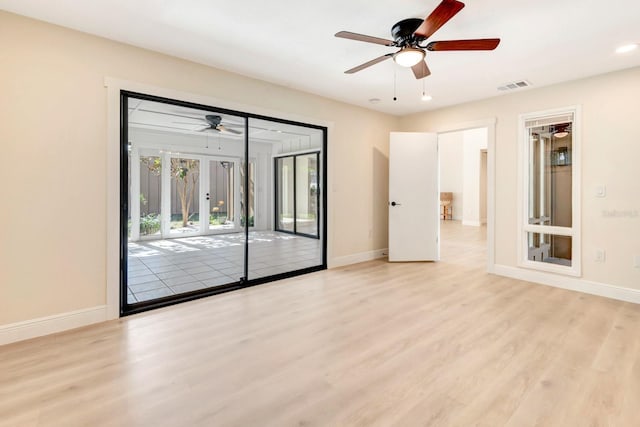 spare room featuring ceiling fan and light wood-type flooring