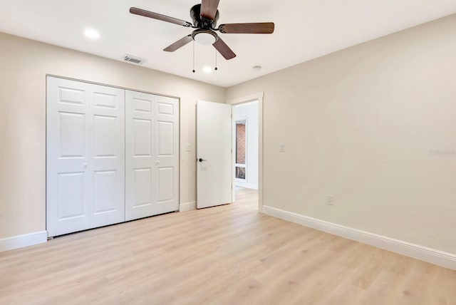 unfurnished bedroom with ceiling fan, a closet, and light hardwood / wood-style floors