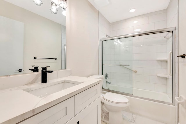 full bathroom featuring shower / bath combination with glass door, vanity, and toilet