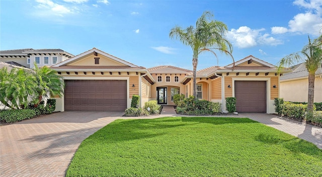 view of front facade featuring french doors, a front lawn, and a garage