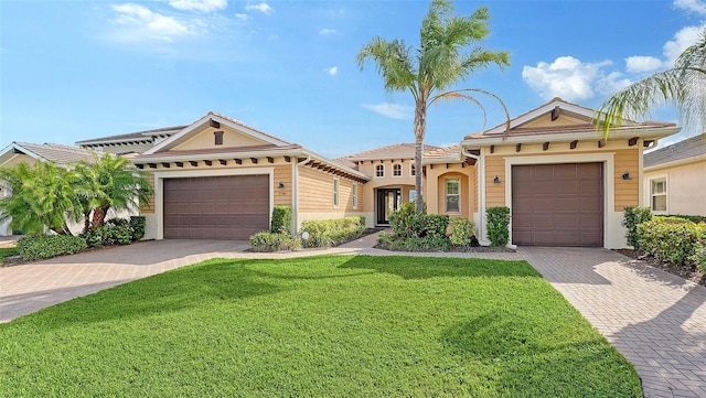 view of front of home with a front yard and a garage