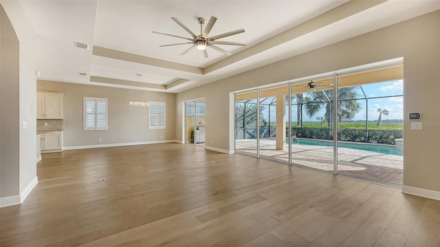 unfurnished living room featuring hardwood / wood-style floors, ceiling fan, and a wealth of natural light