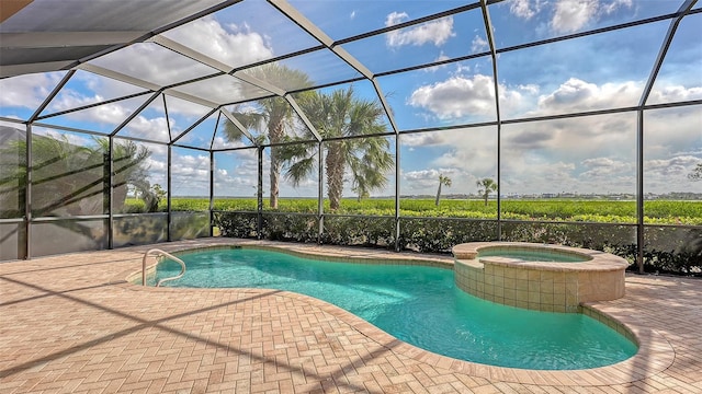 view of swimming pool featuring a lanai, a patio, and an in ground hot tub