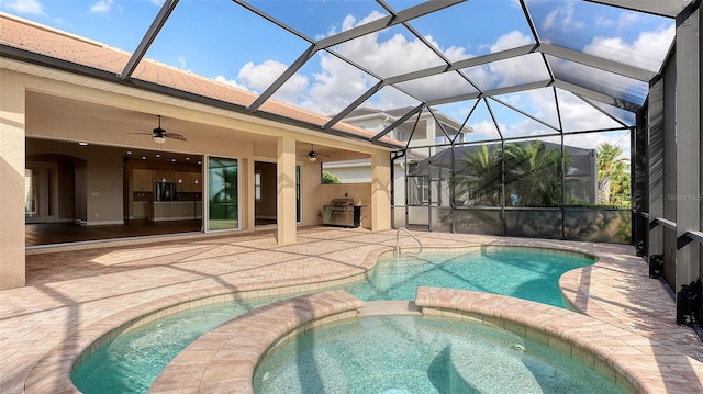 view of swimming pool with a lanai, a patio area, and ceiling fan