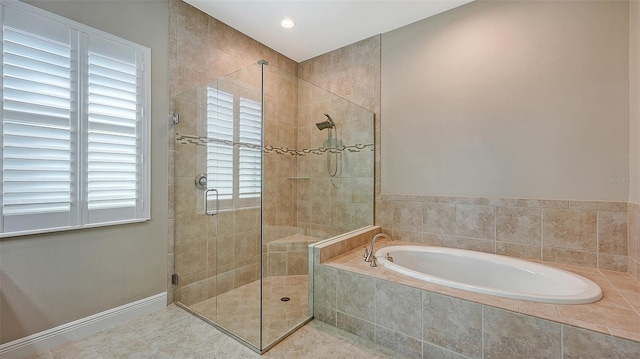 bathroom featuring tile patterned floors and separate shower and tub