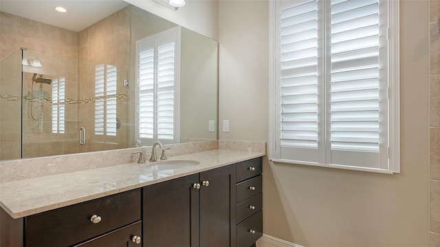 bathroom featuring vanity and an enclosed shower