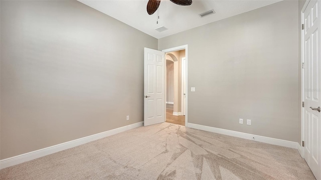 unfurnished bedroom with ceiling fan, light colored carpet, and vaulted ceiling