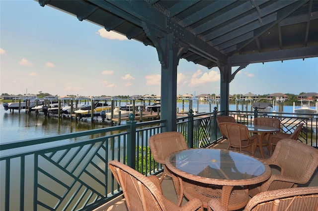 balcony with a water view and a boat dock