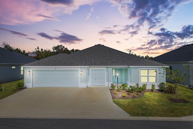 single story home with a lawn and a garage