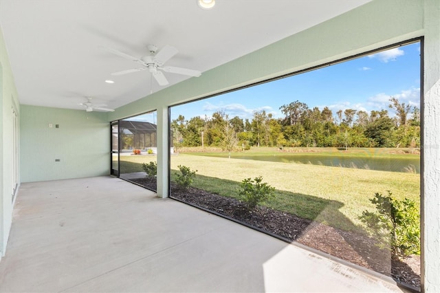 view of patio / terrace with ceiling fan and a water view