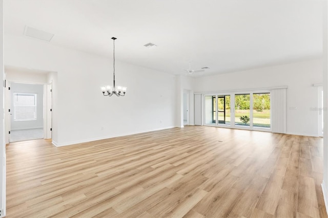 unfurnished living room with light hardwood / wood-style flooring and ceiling fan with notable chandelier