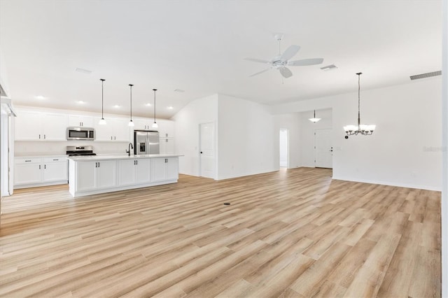 unfurnished living room with light hardwood / wood-style floors and ceiling fan with notable chandelier