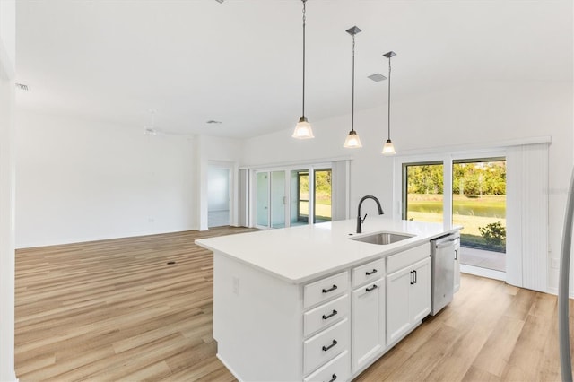 kitchen featuring white cabinets, a kitchen island with sink, a healthy amount of sunlight, and sink