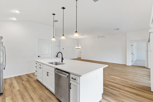 kitchen with appliances with stainless steel finishes, light wood-type flooring, a center island with sink, and white cabinetry