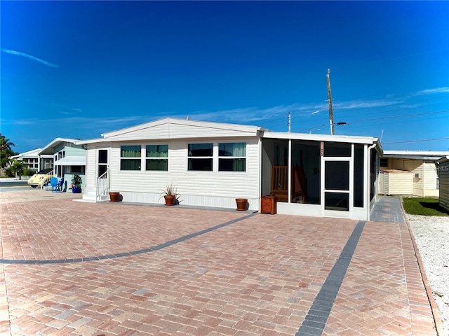 back of property featuring a sunroom