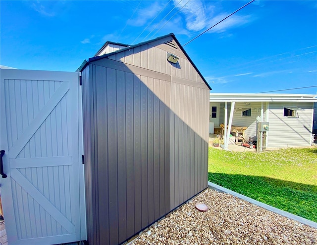 view of outbuilding featuring a yard