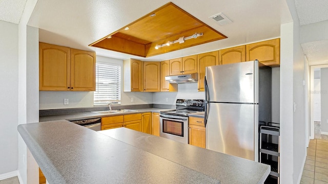 kitchen featuring kitchen peninsula, sink, light tile patterned flooring, and stainless steel appliances