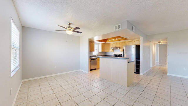 kitchen featuring ceiling fan, plenty of natural light, a kitchen island, and appliances with stainless steel finishes