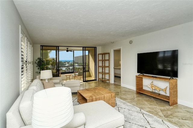 living room featuring a wall of windows and a textured ceiling