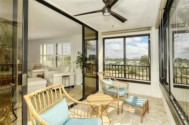 sunroom / solarium featuring ceiling fan