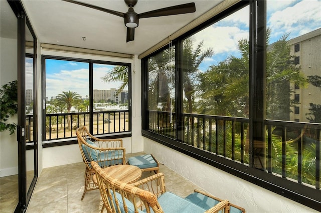 sunroom / solarium featuring ceiling fan