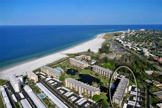 aerial view with a water view and a beach view