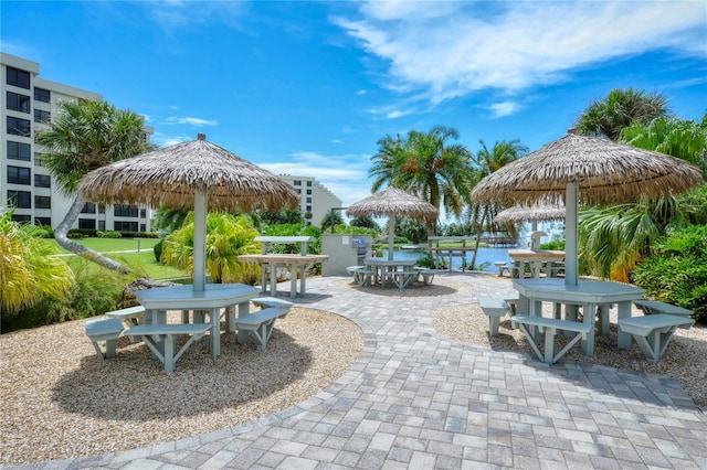 view of property's community with a water view and a patio