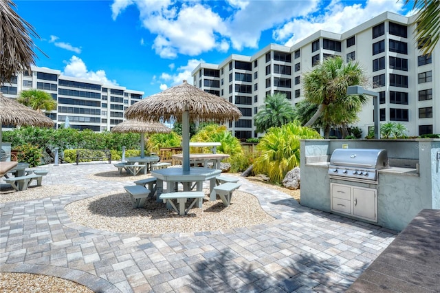 view of patio with an outdoor kitchen and a grill