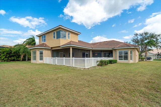 back of property with a yard and a sunroom