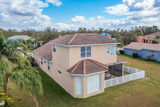 back of property featuring a lawn and central AC unit