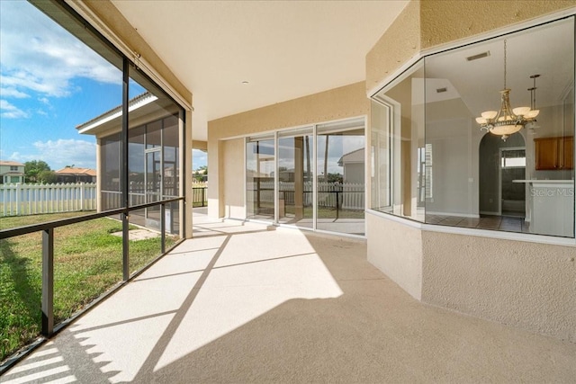 exterior space with vaulted ceiling, a water view, and an inviting chandelier