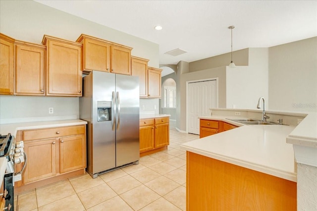 kitchen with pendant lighting, light tile patterned flooring, stainless steel appliances, and sink